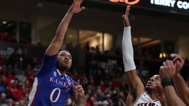 Jan 3, 2023; Lubbock, Texas, USA; Kansas Jayhawks guard Bobby Pettiford Jr (0) shoots over Texas Tech Red Raiders forward guard Lamar Washington (1) in the first half at United Supermarkets Arena.